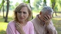 Old couple crying, frustrated with illness of close relative, problems despair