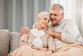 Old couple, hug and relax on couch with love and support, bonding while at home with trust and comfort. People with time Royalty Free Stock Photo