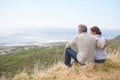 Old couple, hug and sitting on a mountain with love in marriage, retirement or holiday mockup space. Summer, vacation Royalty Free Stock Photo