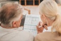 Old couple with mortgage application, retirement and paperwork for insurance, life partner and investment. Marriage
