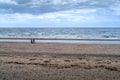 Old couple out for a walk on a beach Royalty Free Stock Photo