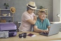 Old couple use pc laptop to buy tour, airline ticket and booking hotel from home Royalty Free Stock Photo