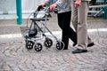 Old couple pushing rollator