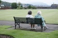 Old couple senior woman park bench summer love relaxing outdoors Rothesay