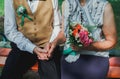 Old couple is sitting on bench in the green park. Grandmother and grandfather at their golden wedding anniversary celebration. Royalty Free Stock Photo