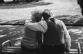 Old couple is sitting on bench in the park. Grandmother and grandfather at their golden wedding anniversary celebration. Fifty Royalty Free Stock Photo