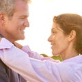 Old couple, smile and embrace at sunset with love, trust and support in marriage and retirement. Happy, woman and care Royalty Free Stock Photo