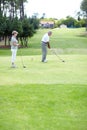 Old couple, sports or golfer playing golf for fitness, workout or exercise to swing on a course or field. Senior woman Royalty Free Stock Photo