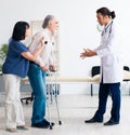 Old couple visiting young male doctor Royalty Free Stock Photo