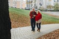 Old couple is walking in the green park. Fifty years together love story. Grandma and grandpa kissing. Grandmother and grandfather Royalty Free Stock Photo