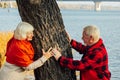 Old couple is walking in the green park. Fifty years together love story. Grandma and grandpa kissing. Grandmother and grandfather Royalty Free Stock Photo