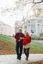 Old couple is walking in the green park. Fifty years together love story. Grandma and grandpa kissing. Grandmother and grandfather Royalty Free Stock Photo