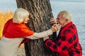 Old couple is walking in the green park. Fifty years together love story. Grandma and grandpa kissing. Grandmother and grandfather Royalty Free Stock Photo