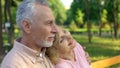 Old couple watching sunset in park, happy marriage romance, relaxing countryside