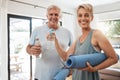 Old couple, yoga mat and water bottle in home ready for fitness, training and meditation. Zen, health and pilates Royalty Free Stock Photo