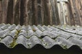 Old and covered with moss wavy roof slates covers the barn Royalty Free Stock Photo