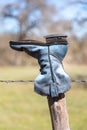 Old cowboy boot hanging on a fence in the Texas Hill Country Royalty Free Stock Photo