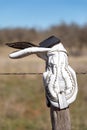 Old cowboy boot hanging on a fence in the Texas Hill Country Royalty Free Stock Photo