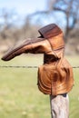 Old cowboy boot hanging on a fence in the Texas Hill Country Royalty Free Stock Photo