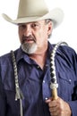 Old cowboy holding bullwhip Royalty Free Stock Photo