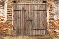 Old cowshed. Large wooden gate and dried wood. Old brick building Royalty Free Stock Photo