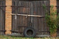 Old cowshed. Large wooden gate and dried wood. Old brick building Royalty Free Stock Photo