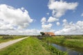 Old farmhouse by river over blue sky Royalty Free Stock Photo
