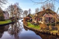 Old cozy house with thatched roof in Giethoorn, Netherlands.