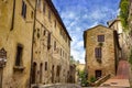 Old cozy street in in old town of San Gimignano, Tuscany, Italy. San Gimignano is typical Tuscan medieval town in Italy Royalty Free Stock Photo