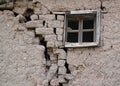 Old cracked adobe wall with window Royalty Free Stock Photo