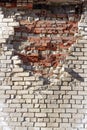 Old cracked brick wall of a building with cement joints on a bright sunny day. Wallpaper. Background Royalty Free Stock Photo