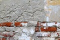 Old cracked brick wall with cracks and hollows.