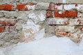 Old cracked brick wall with cracks and hollows.