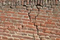 Old cracked brick wall. Damaged masonry, Deteriorated brickwork.