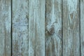 Old, cracked planks with peeling blue-gray paint faded in the sun Royalty Free Stock Photo