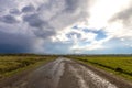 Old cracked road after rain. Bad bumpy street with holes and sto Royalty Free Stock Photo