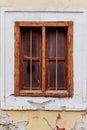Old cracked wall with a window. window of old house. Old window with brown frame Royalty Free Stock Photo