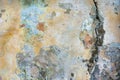 Old cracked weathered painted wall background texture. Light peeled plaster wall with falling off flakes of paint Royalty Free Stock Photo