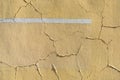 Old cracked weathered painted wall background texture. Yellow color wall with white line. Royalty Free Stock Photo