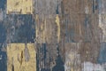 Old cracked wooden chessboard texture with black and yellow tern squares, texture background