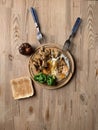 Old cracked wooden round board with lunch on an old kitchen wooden table. Scrambled eggs, broccoli and fried chicken breast pieces Royalty Free Stock Photo
