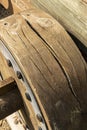 Old cracked wooden wheel of an ancient cannon Royalty Free Stock Photo