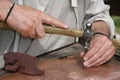 Old craftsman Mason during the processing of a copper with an en