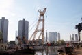 Old crane in harbor named Leuvehaven in downtwon Rotterdam on sunny day