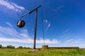 Old crane well on the field in summer under blue sky Royalty Free Stock Photo