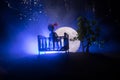 Old creepy eerie wooden baby crib in dark toned foggy background. Horror concept. Scary baby and bed silhouette in dark. Halloween