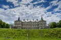 Old creepy huge dark castle on the hill under the blue sky Royalty Free Stock Photo