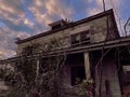 Old creepy scary wooden overgrown abandoned mansion scary theme Royalty Free Stock Photo
