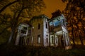 Old creepy wooden abandoned haunted mansion at night Royalty Free Stock Photo