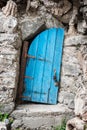 Old crooked blue wooden door in Crete Greece Royalty Free Stock Photo